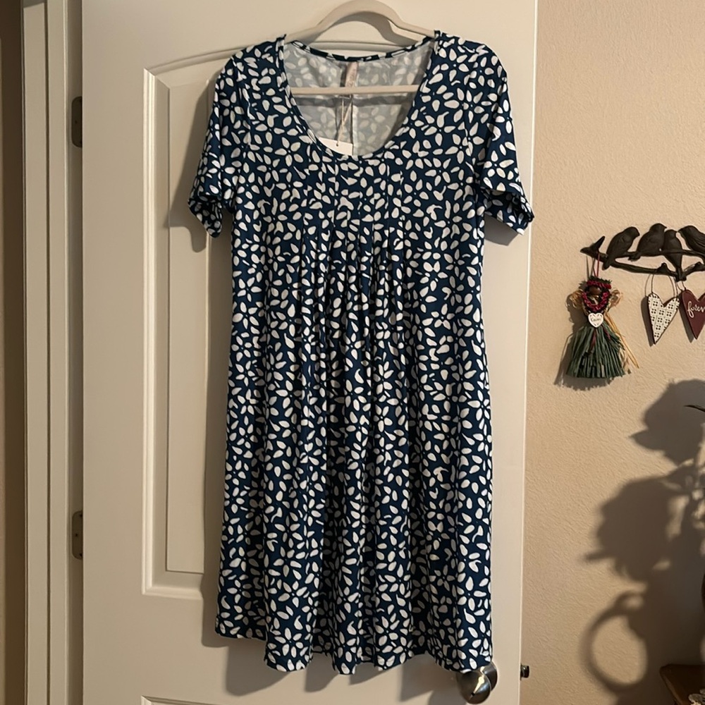 Cute short sleeve dress with pockets. Size medium, blue with white flowers.